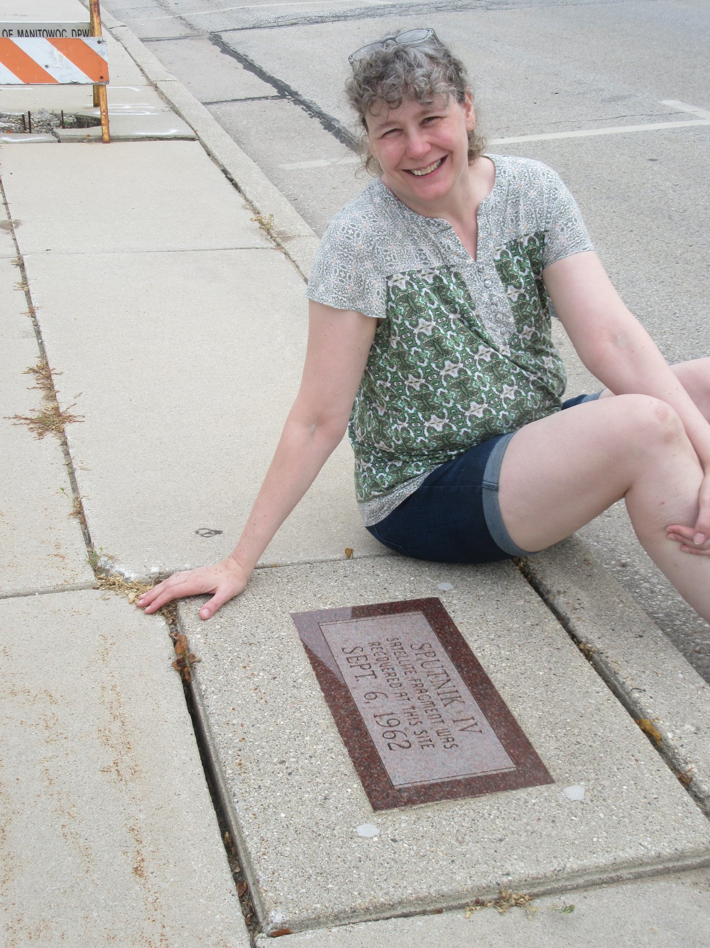 Shawn smiling by what looks like a grave marker