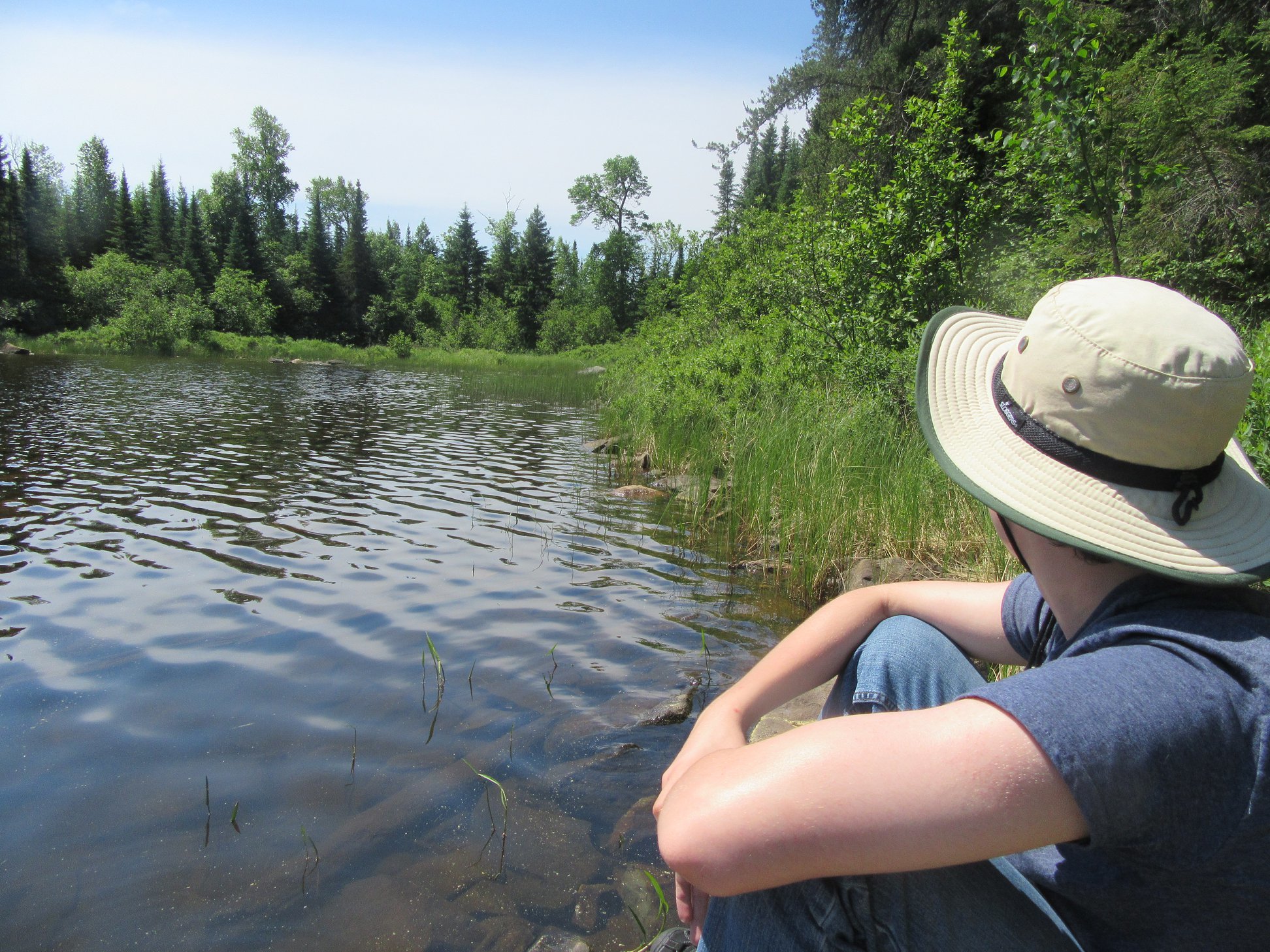 A different view of a north woods lake, with a profile of Mason in his sun hat.