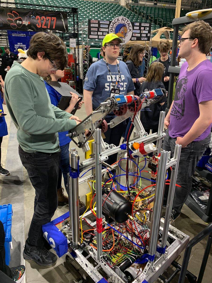 Mason and his team working the robot