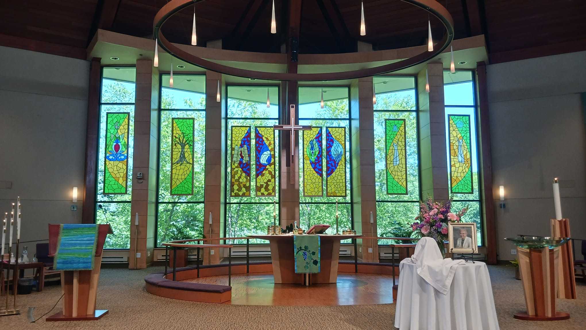 Not the usual full panes of stained glass, instead art pieces hung in front of a circular bay of windows. 